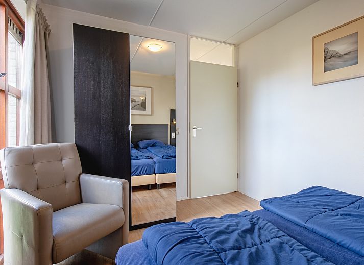 Cozy living room in Villapark Residence Texel No. 719, vacation home in De Cocksdorp, Texel with stylish sitting area and fireplace.