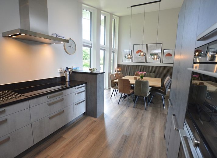 Stijlvolle woonkamer van Orchismient 49 in De Koog, Texel met uitzicht op de natuur.