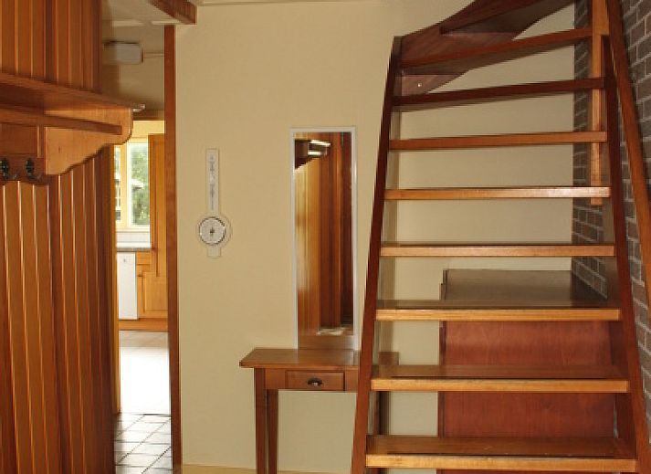 Cozy living room of Landhuis Landleven No. 81 in De Koog, Texel with comfortable sitting area and wood stove.