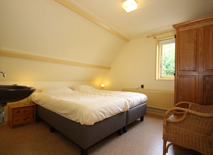 Cozy living room of Landhuis Landleven No. 81 in De Koog, Texel with comfortable sitting area and wood stove.