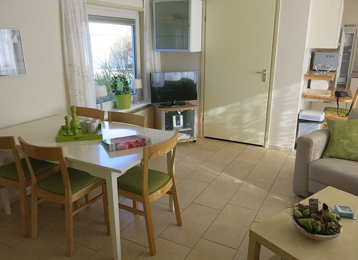 Gezellige woonkamer van Bungalow 't Luwe Land 49 in De Koog Texel, met comfortabele banken en uitzicht op de natuur van de Waddeneilanden.