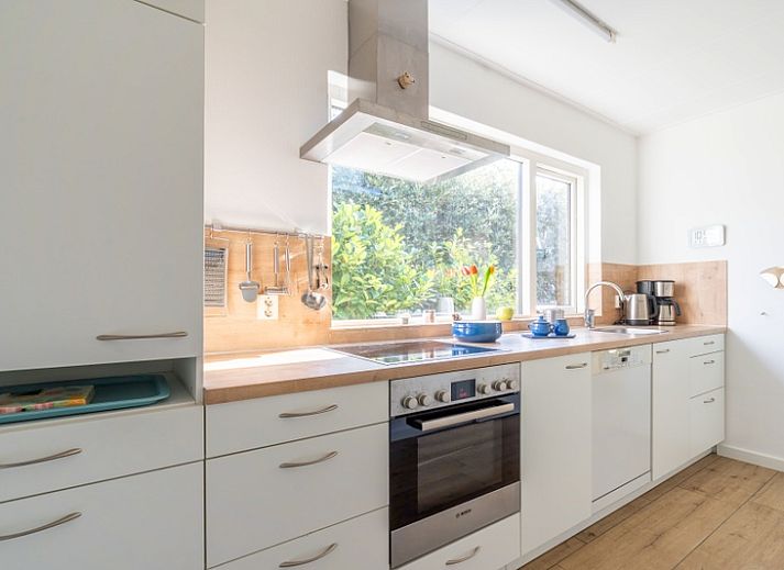 Bright living room in Orchismient 14 vacation home, De Koog Texel with comfortable seating area.