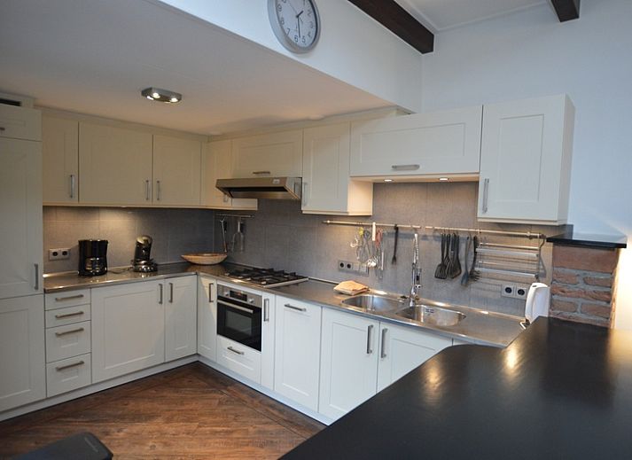 Ingang van Orchismient 28 in De Koog Texel met bakstenen muren en glazen deur.