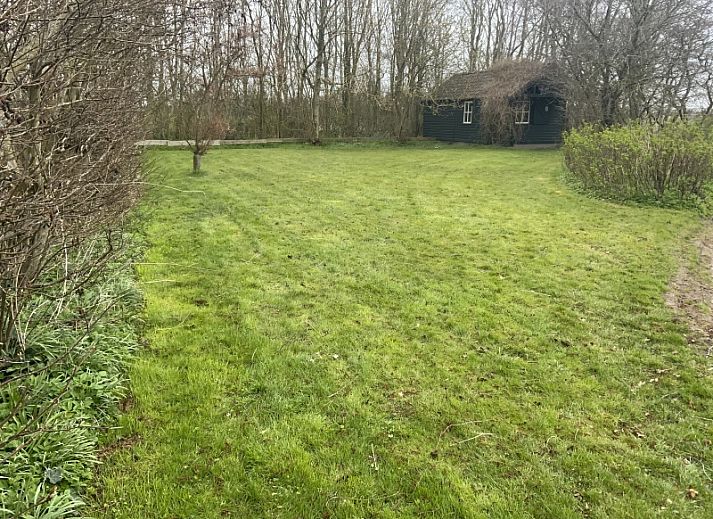 Luchtfoto van vakantiehuis Achterhuis in De Koog, Texel, met ruime groene omgeving.