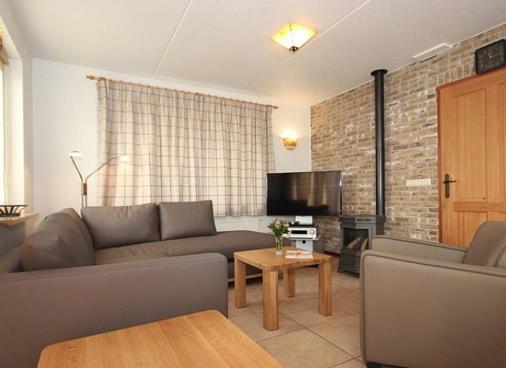 6 Person luxury villa with sauna in De Koog, Texel, surrounded by green nature and terrace with parasol.