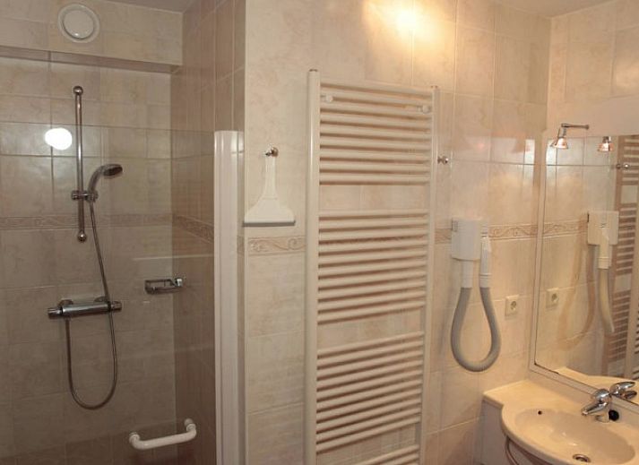 Cozy living room in 6 Person luxury villa with sauna, De Koog, Texel, with comfortable sitting area and fireplace.