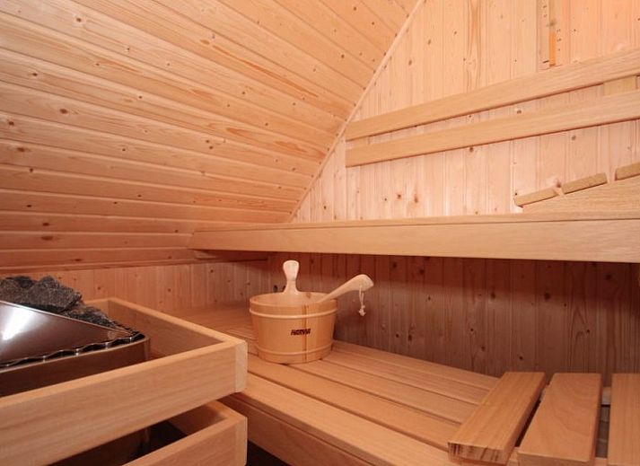 Cozy living room in 6 Person luxury villa with sauna, De Koog, Texel, with comfortable sitting area and fireplace.