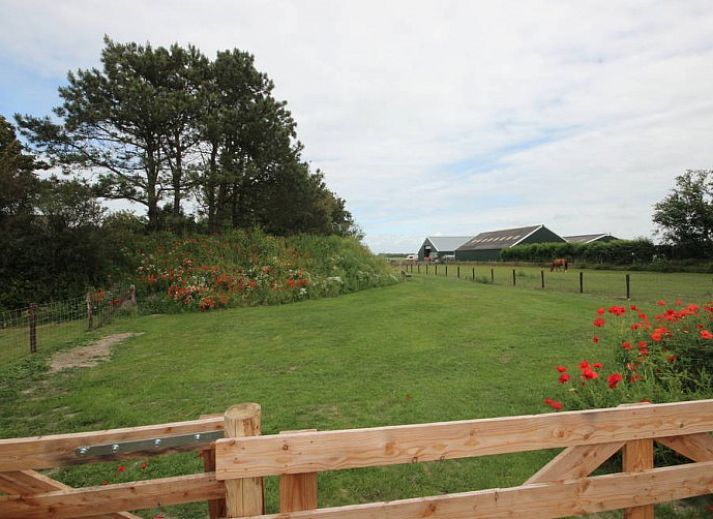 Cozy living room in 6 Person luxury villa with sauna, De Koog, Texel, with comfortable sitting area and fireplace.