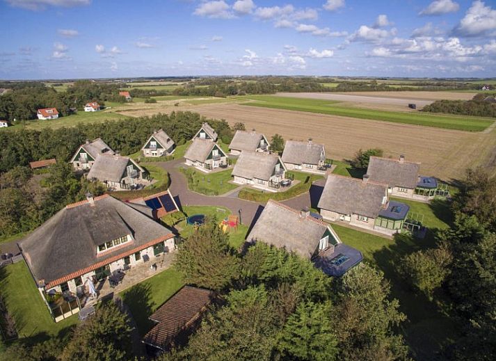 Cozy living room in 6 Person luxury villa with sauna, De Koog, Texel, with comfortable sitting area and fireplace.