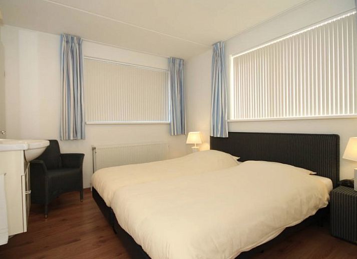 Cozy living room in 6 Person luxury villa, De Koog, Texel, with open kitchen and comfortable seating area.