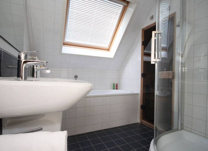 Cozy living room in 6 Person luxury villa, De Koog, Texel, with open kitchen and comfortable seating area.