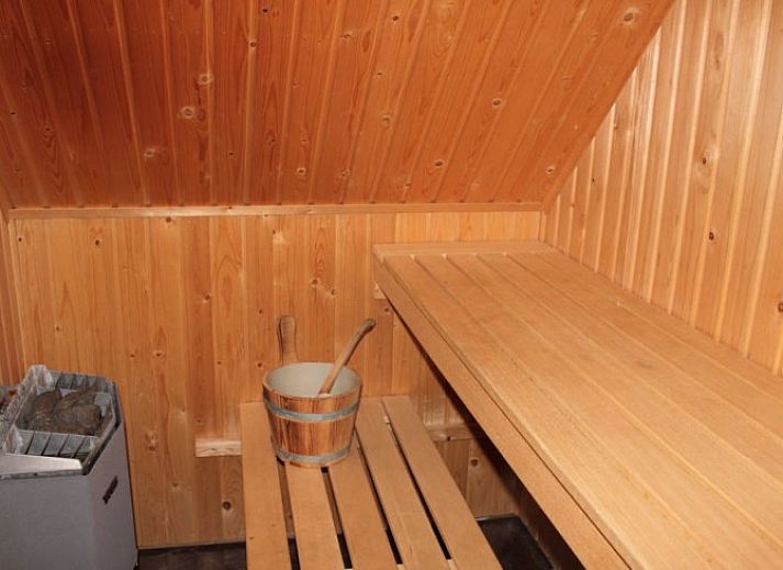 Cozy living room in 6 Person luxury villa, De Koog, Texel, with open kitchen and comfortable seating area.