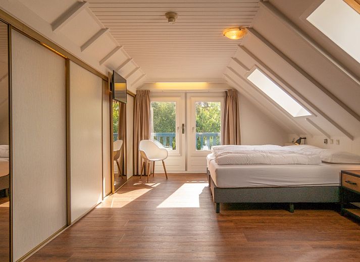 Cozy indoor area with fireplace in Kamerstraat 66 vacation home in De Koog Texel for cozy evenings.