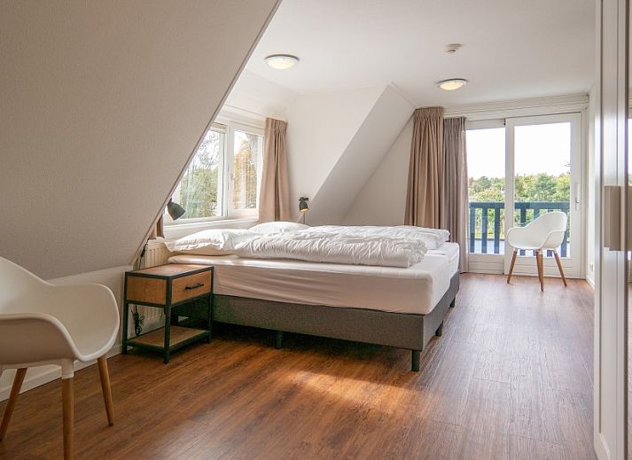 Cozy indoor area with fireplace in Kamerstraat 66 vacation home in De Koog Texel for cozy evenings.