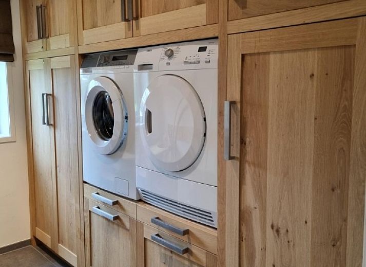 Elegante eetkamer in Villa Duyncoogh, De Koog, Texel, met een lange tafel en wanddecoratie van natuur op de Waddeneilanden.