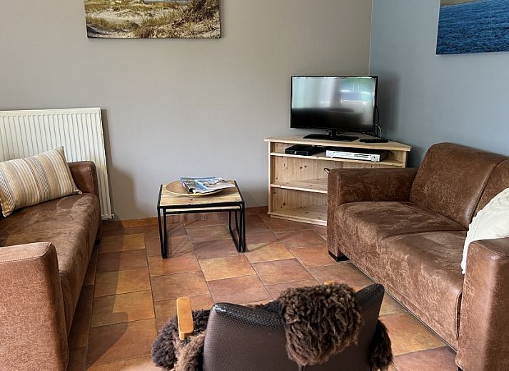 Koetshuis vakantiehuis in De Koog, Texel met charmant terras en groene omgeving, ideaal voor een ontspannen verblijf op de Waddeneilanden.