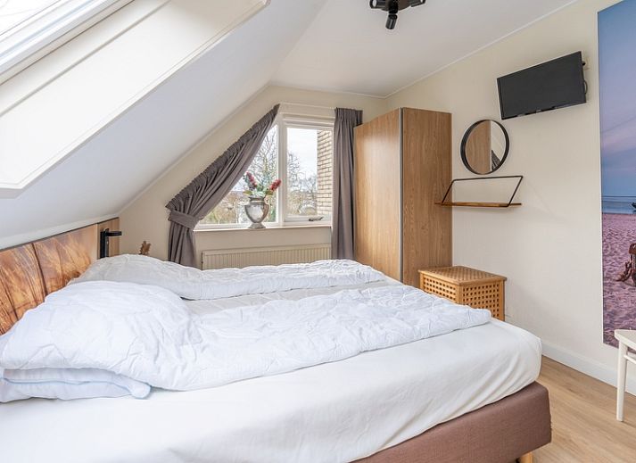 Gemuetliches Wohnzimmer des Ferienhauses Kamperfoelie 33 in De Koog, Texel mit komfortabler Sitzecke.