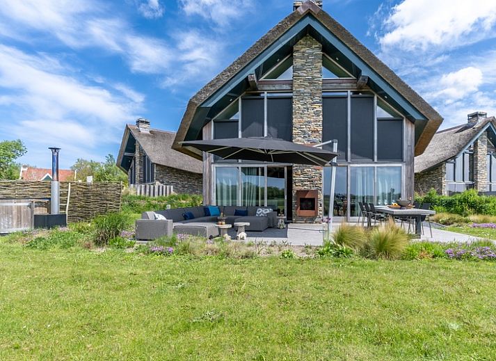 Villa 191 with Hot tub in De Koog, Texel, vacation home with spacious garden and modern terrace for ultimate outdoor fun.