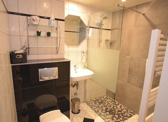 Lichte woonkamer van Appartement Kerckeland 20, De Koog, Texel met uitzicht op de groene omgeving.