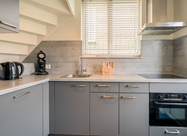 Cozy living room of De Bosruiter, vacation home in De Koog, Texel with comfortable sofa and decorations.