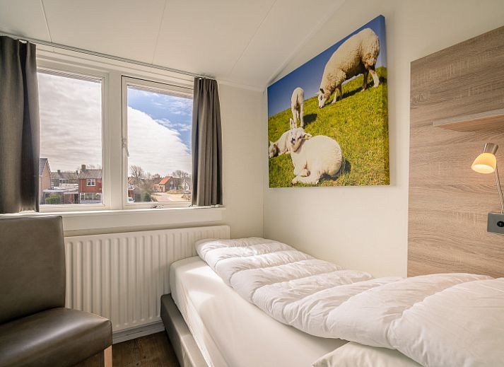 Cozy living room of De Bosruiter, vacation home in De Koog, Texel with comfortable sofa and decorations.