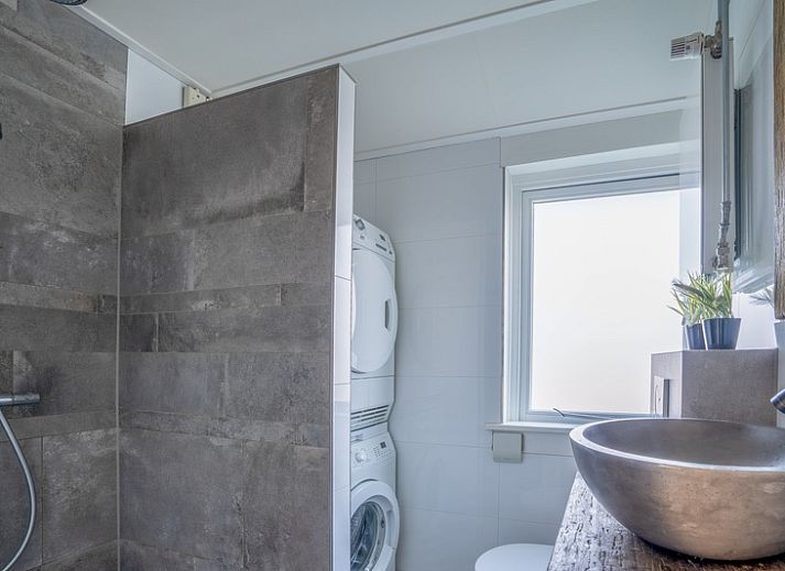 Cozy living room of De Bosruiter, vacation home in De Koog, Texel with comfortable sofa and decorations.