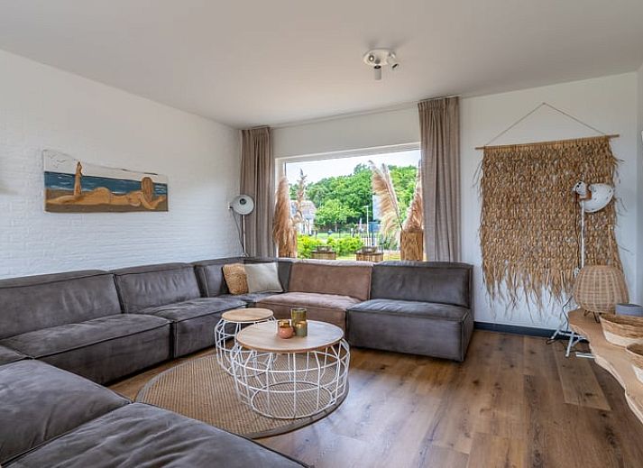 Gezellige woonkamer van Huisje in De Koog, Texel, met uitzicht op het landschap van de Waddeneilanden.