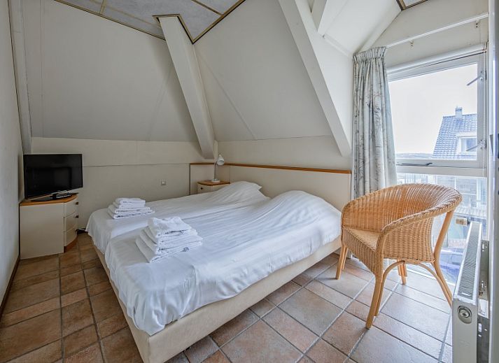 Gemuetliches Wohnzimmer des Resort De Buteriggel - Appartement 0 in De Koog, Texel, mit bequemen Sitzgelegenheiten.