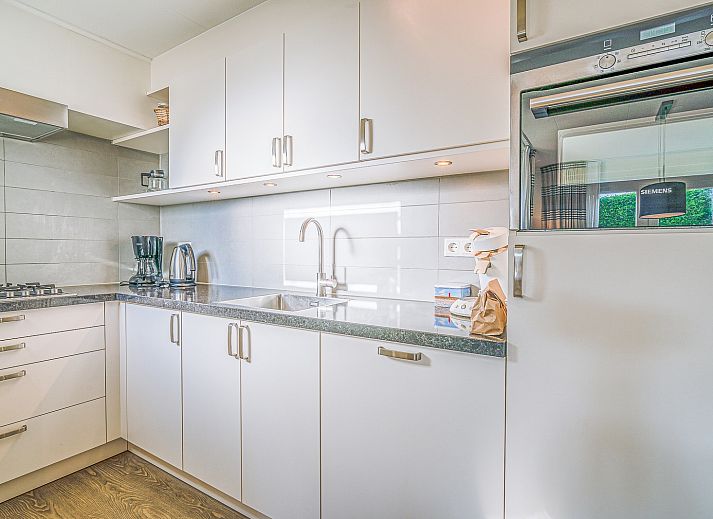 Cozy terrace at Holiday home Honeysuckle 49 in De Koog Texel, perfect for outdoor activities on the Wadden Islands.