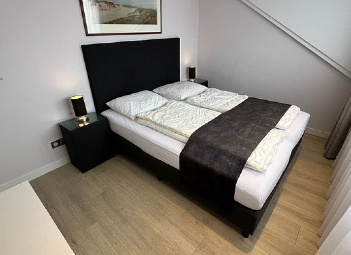 Moderne binnenruimte van Vakantiehuis Duinzee Texel in De Koog, ideaal voor ontspanning en gezelligheid.