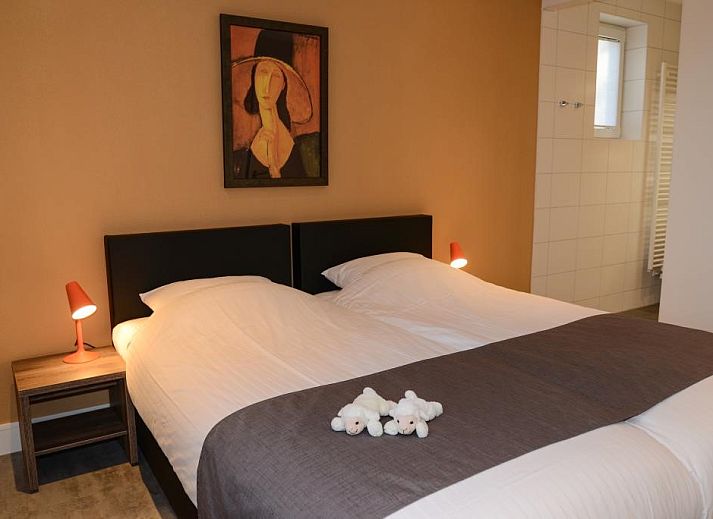 Modern living room in 06 - Razende Bol - allotment vacation home in De Koog, Texel with open kitchen.