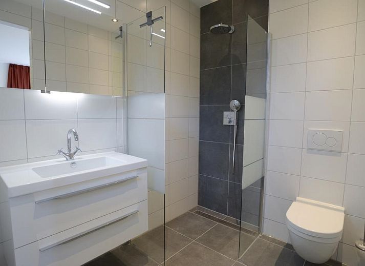 Modern living room in 06 - Razende Bol - allotment vacation home in De Koog, Texel with open kitchen.