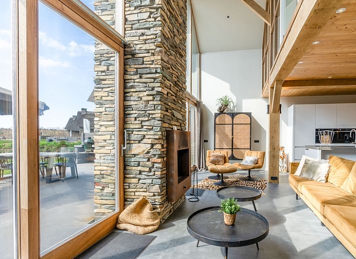 Villa 181 with Hot tub in De Koog, Texel offers a spacious terrace with modern seating area surrounded by nature on the Wadden Islands.