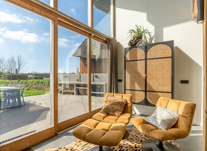 Villa 181 with Hot tub in De Koog, Texel offers a spacious terrace with modern seating area surrounded by nature on the Wadden Islands.