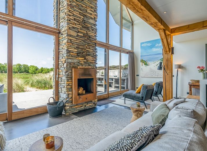 Villa 193 in De Koog, Texel, vakantiehuis met moderne architectuur en rieten dak omgeven door duinen.