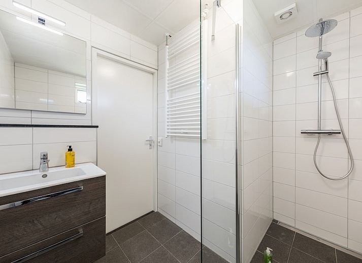 Gezellige woonkamer van T4M Comfort bungalow in De Koog, Texel, met moderne inrichting en uitzicht op de groene omgeving van de Waddeneilanden.