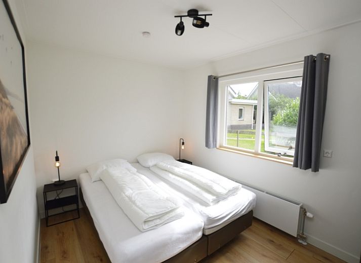 Gemuetliches Wohnzimmer des Ferienhauses Stappeland 203 in De Koog, Texel mit bequemer Sitzecke.