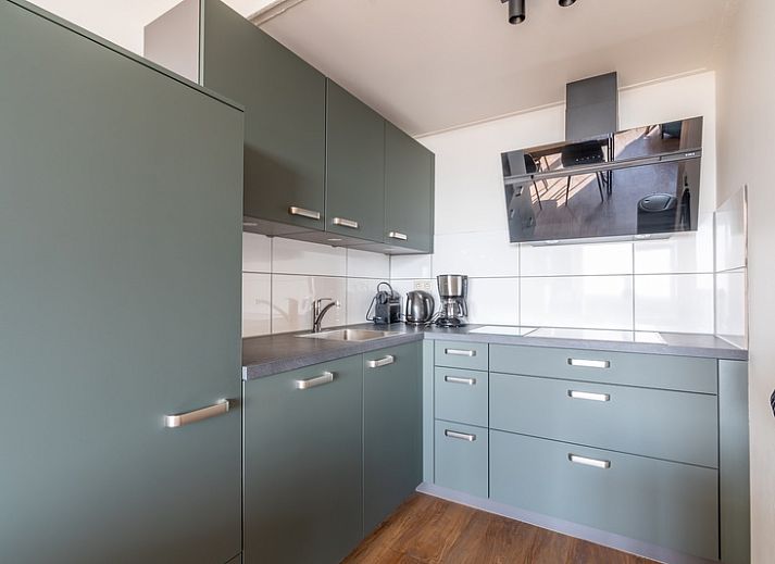 Lichte en ruime binnenruimte van Appartement Juliana 122 Eilandzicht in De Koog, Texel met comfortabele zithoek.