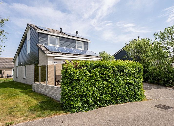 Vakantiehuis Stappeland 169 in De Koog, Texel met zonnige buitenkant en groene omgeving.