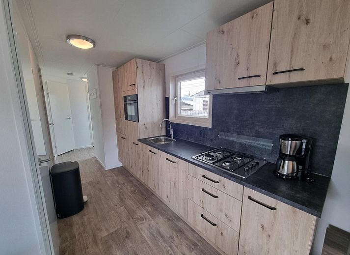 Spacious living room in Chaletpark Bregkoog - Chalet 240 De Texelse Berg, De Koog, Texel with comfortable sitting area and dining area.