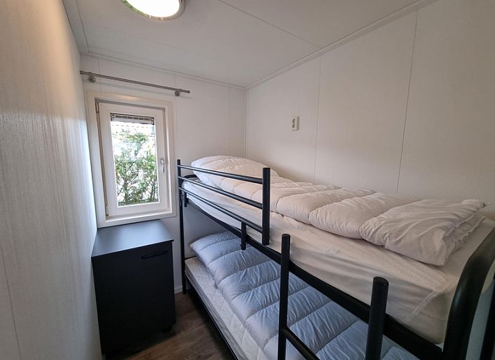 Exterior of Chalet Park Bregkoog - Chalet 240 De Texelse Berg, De Koog, Texel with modern terrace and parking.