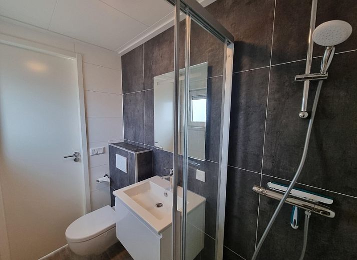 Cozy indoor area of Chaletpark Bregkoog - Chalet 240 De Texelse Berg, De Koog, Texel with sitting area and dining area.