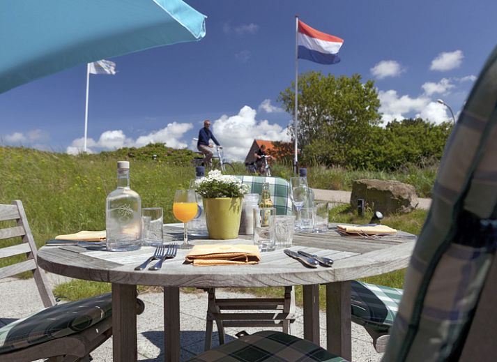 Exterior of Grand Hotel Opduin - Holiday Apartment A in De Koog, Texel, surrounded by natural beauty and bicycle paths.