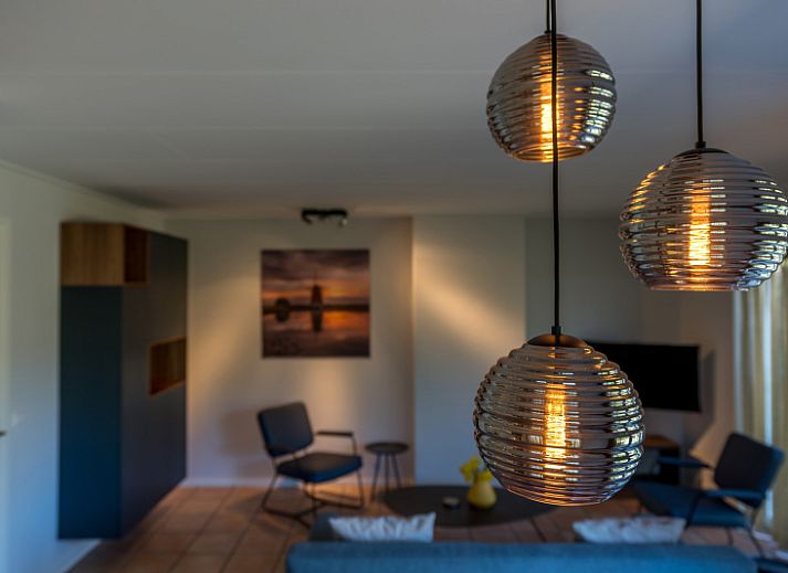 Ingang van Zilte Bries vakantiehuis in De Koog, Texel, met welkomsbord en groene omgeving.