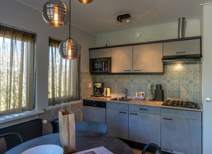 Ingang van Zilte Bries vakantiehuis in De Koog, Texel, met welkomsbord en groene omgeving.