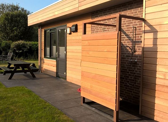 Terrace of Park Verste Coogh vacation home in De Koog, Texel with modern garden table.