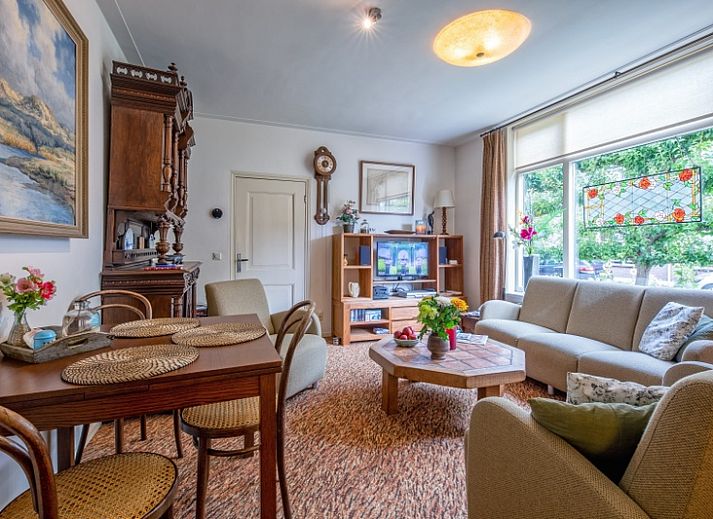 Charmanter Eingang zum Appartement Moleneind in De Waal, Texel, mit buntem Garten und Fahne.