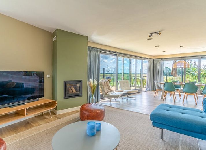 Vakantiehuisje in De Waal, Texel met prachtig uitzicht op het platteland bij zonsondergang.