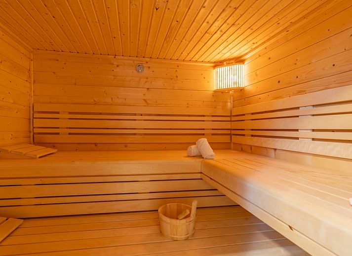 Stijlvolle woonkamer met blauwe banken in Vakantiehuisje in De Waal, Texel.