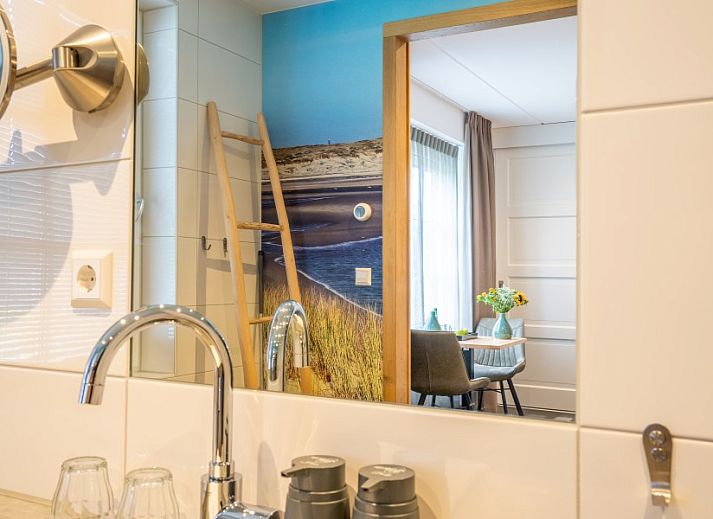 Spacious living room in Group Residence Nieuw Leven Texel, Den Burg, with modern furnishings and lots of natural light.